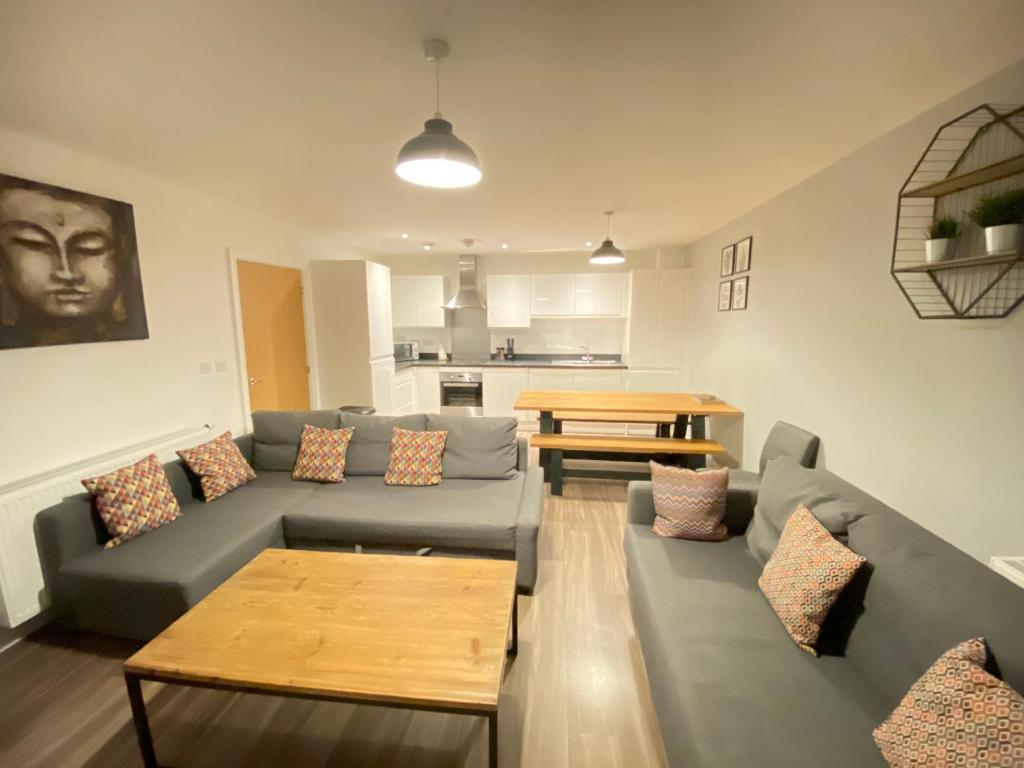 a living room with a couch and a table at 3 Bedrooms double or single beds, 2 PARKING SPACES! WIFI & Smart TV's, Balcony in Portsmouth