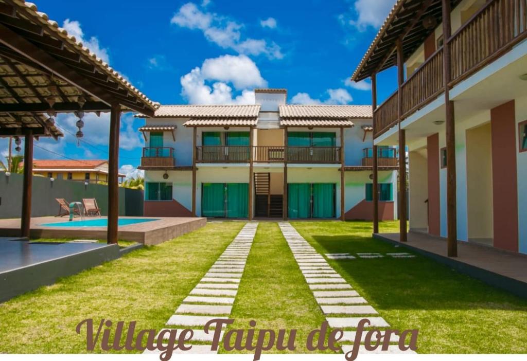 a villa with a yard and a swimming pool at Village Taipu de Fora in Marau