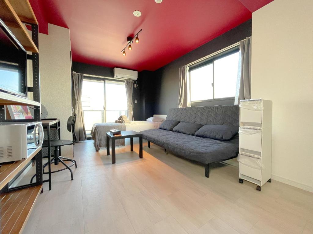 - un salon avec un canapé et un plafond rouge dans l'établissement Mr Kintaro Hotel Asakusa South, à Tokyo