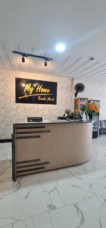 a restaurant with a counter in the middle of a room at My Home Aceh in Banda Aceh