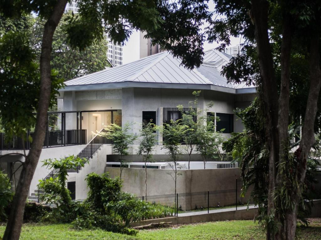 a white house with a metal roof at Lloyd's Inn in Singapore