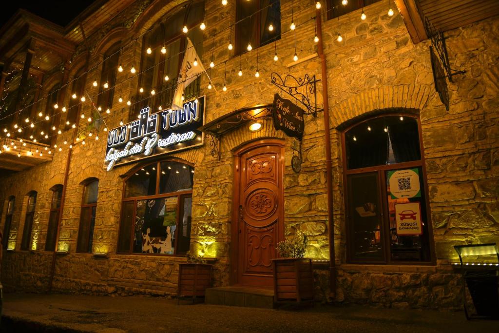 a building with a neon sign on the side of it at Old Town Sheki in Sheki