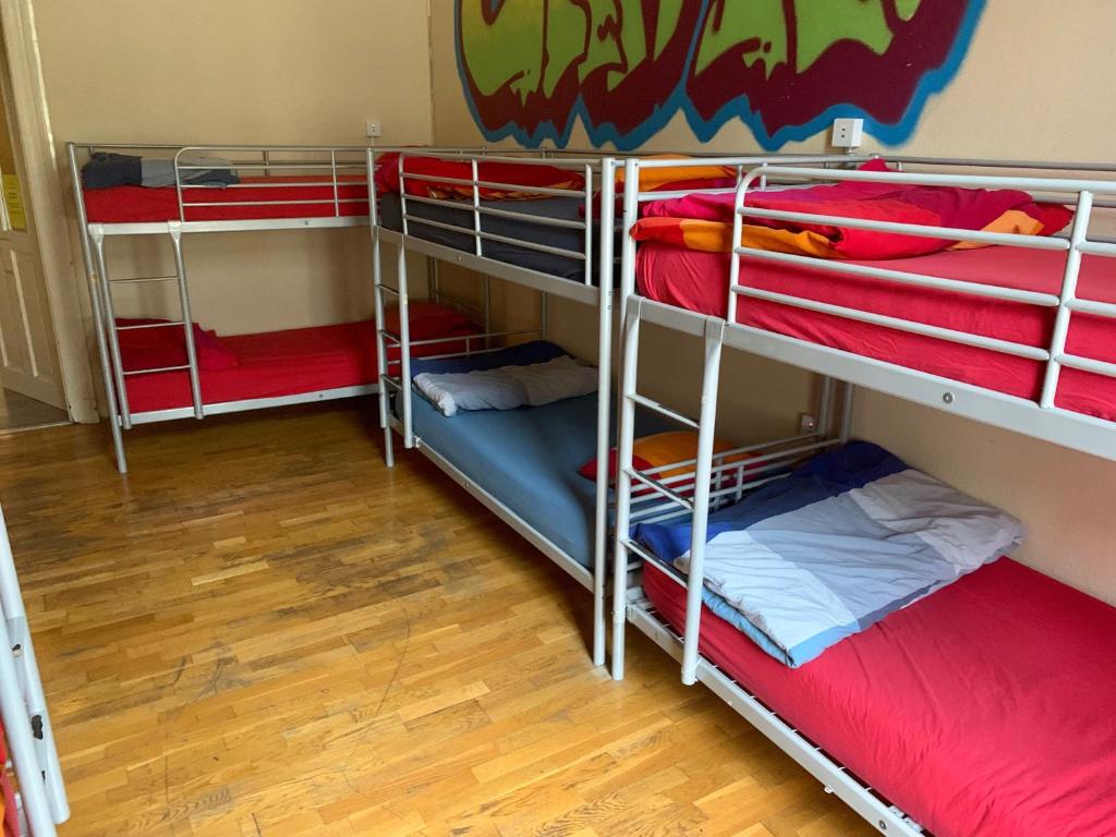 a group of bunk beds in a room at Carpe Noctem Hostel in Budapest