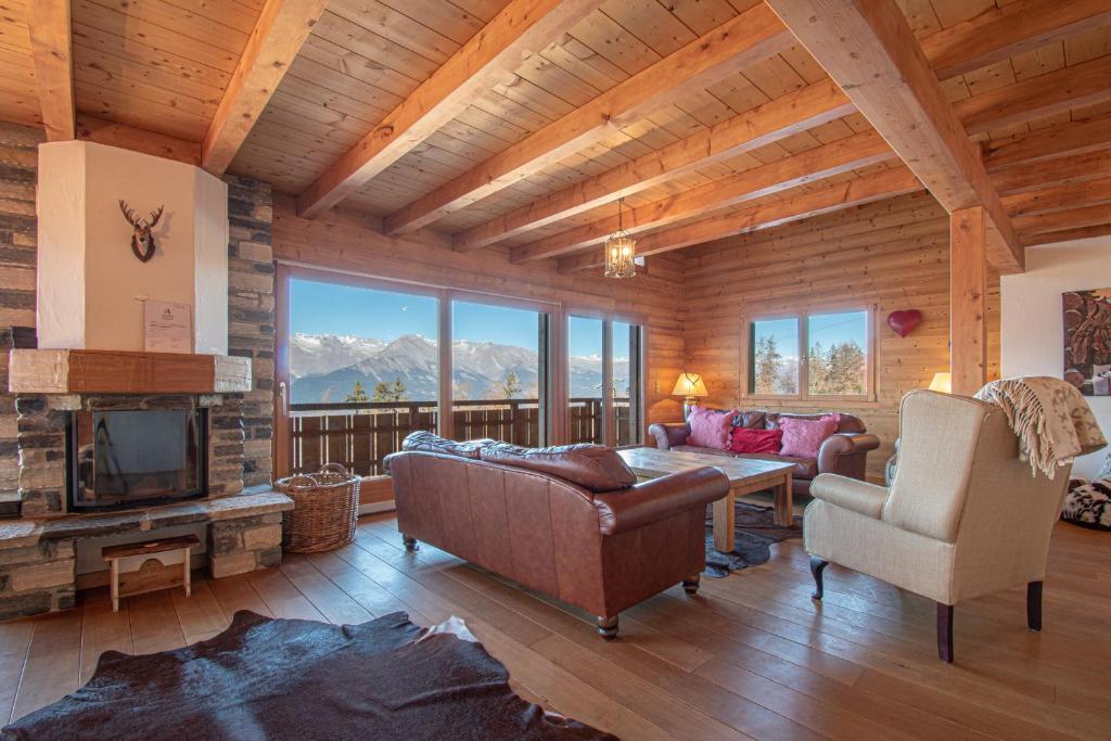 a living room with a couch and a fireplace at Hirondelle JACUZZI & LUXURY chalet 12 pers by Alpvision Résidences in Veysonnaz