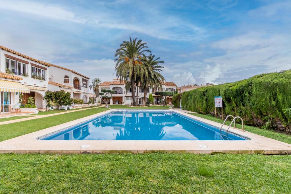 a swimming pool in the yard of a house at Spacious Ground Floor Apartment in Denia