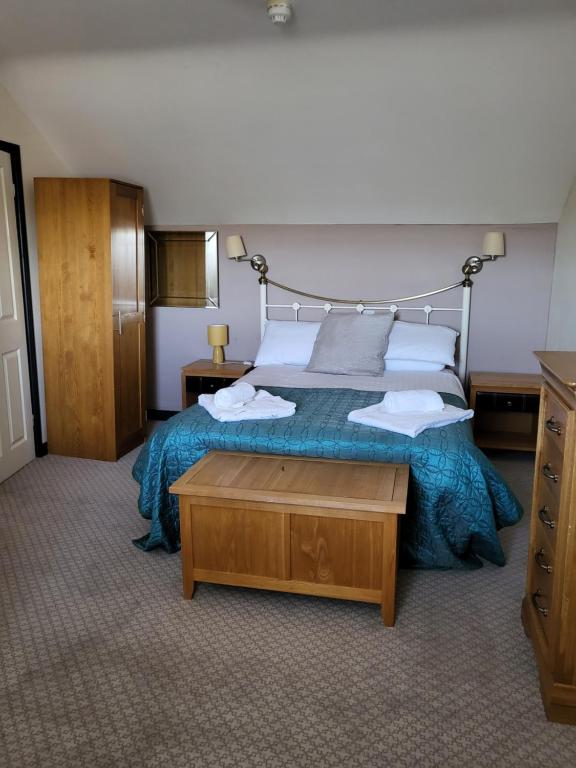 a bedroom with a large bed with a blue bedspread at The Stores in Aberystwyth