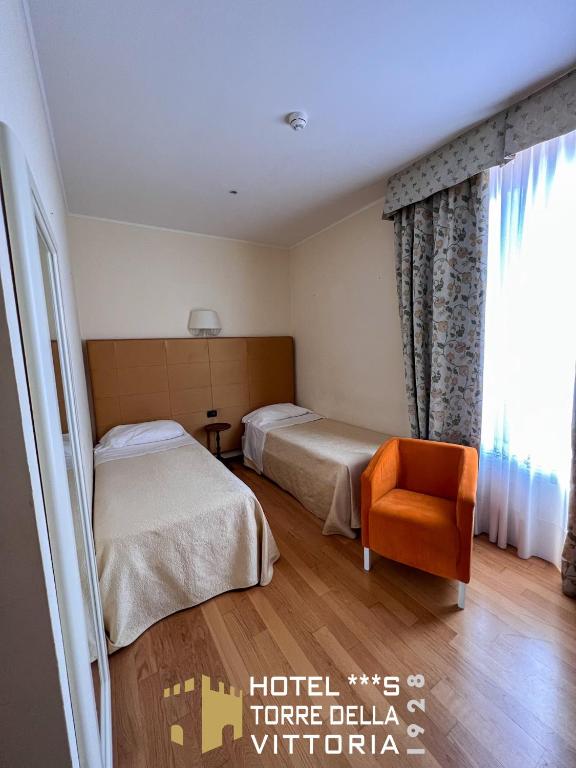 Postel nebo postele na pokoji v ubytování Hotel Torre della Vittoria 1928