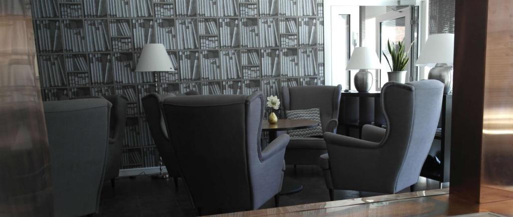 a dining room with chairs and a table and a wallpaper at Scandic Gällivare in Gällivare