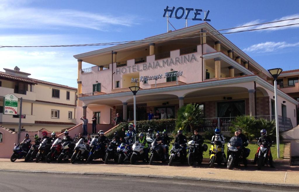 motorcycles parked in front of a building at Hotel Baia Marina in Orosei