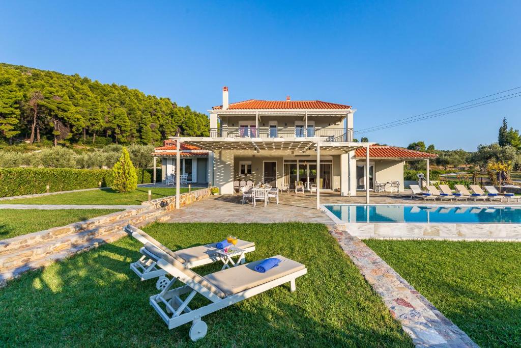 a villa with a swimming pool and a house at Luxury Villa with Private Pool in Skopelos, Ideal for Families, Villa Aelia by Kardous in Alikias