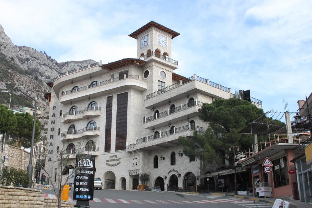 a building with a clock tower on top of it at Rooms Panorama in Krujë