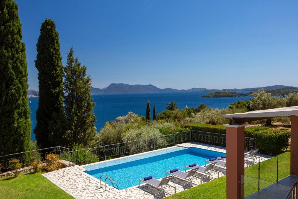 a villa with a swimming pool and a view at Ionian Luxury Villas in Nikiana