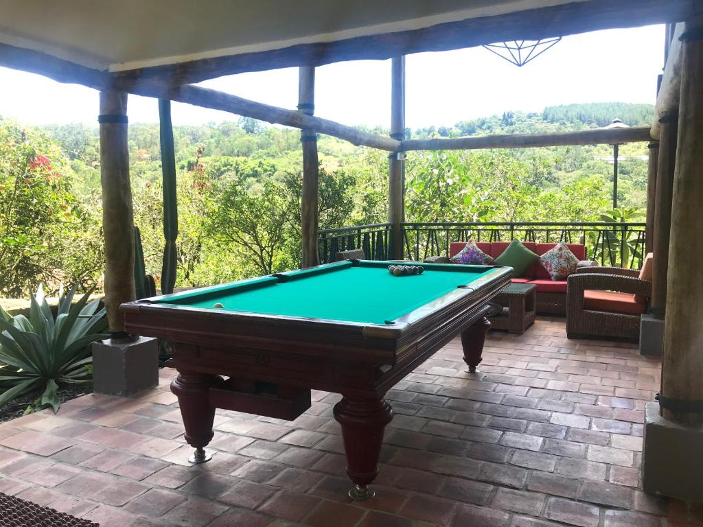 una mesa de billar en un porche cubierto con vistas en Hotel Casas de Campo El Ciruelo, en San Gil