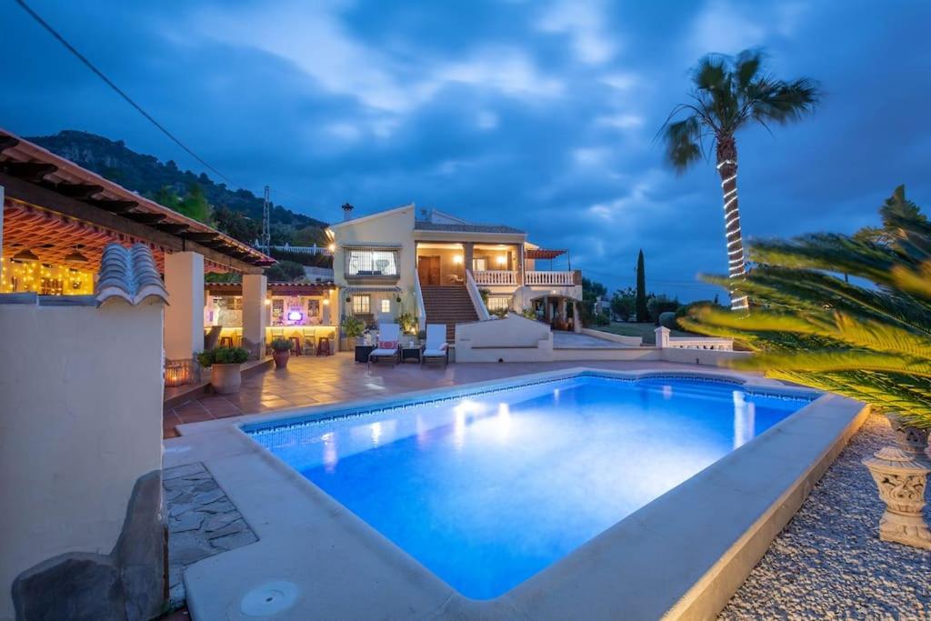 a swimming pool in front of a house at Castillo Esmeralda in Alhaurín de la Torre