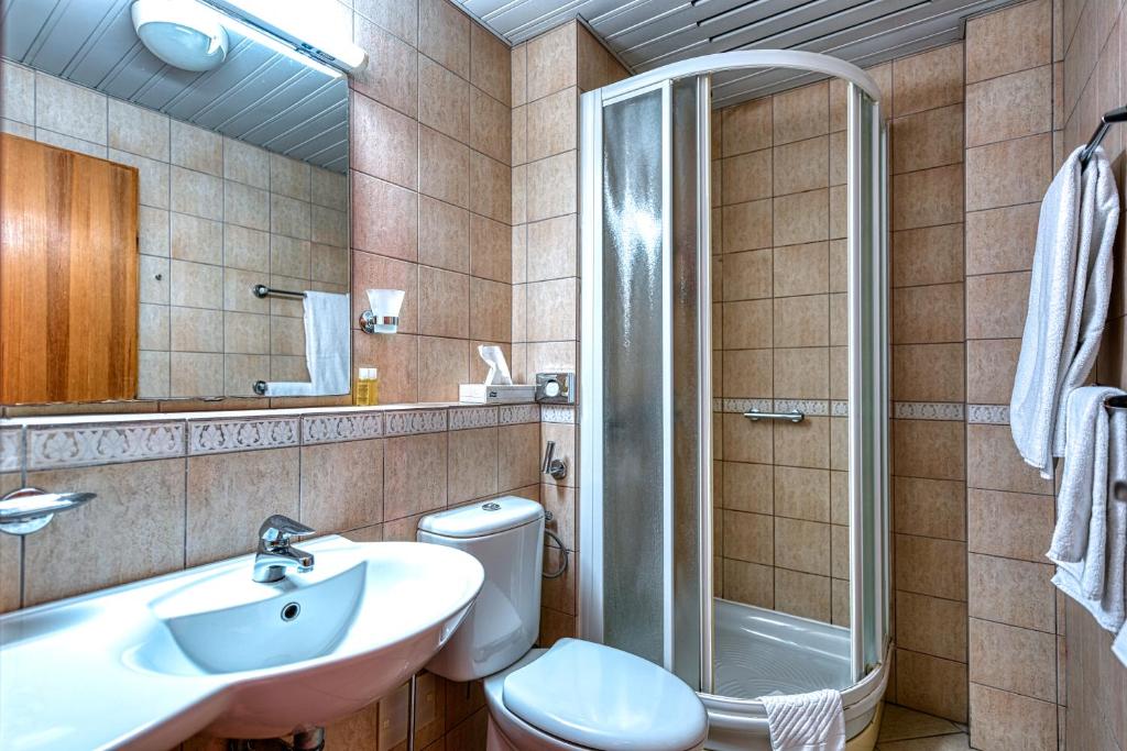 a bathroom with a toilet and a sink and a shower at Hotel Splendido in Kotor