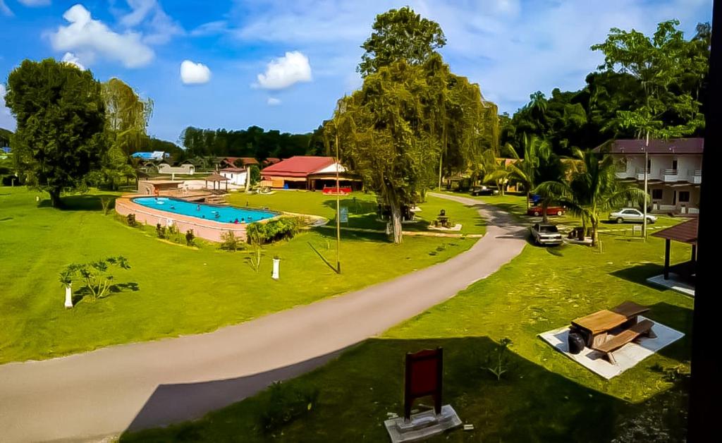 an aerial view of a park with a swimming pool at TELUK PENYABUNG RESORT in Kampung Mawar