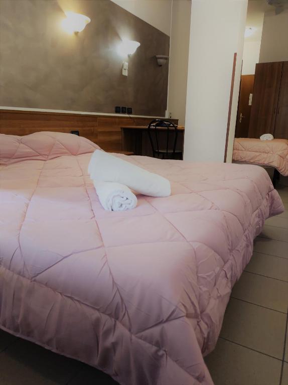 Postel nebo postele na pokoji v ubytování Hotel Marinoni