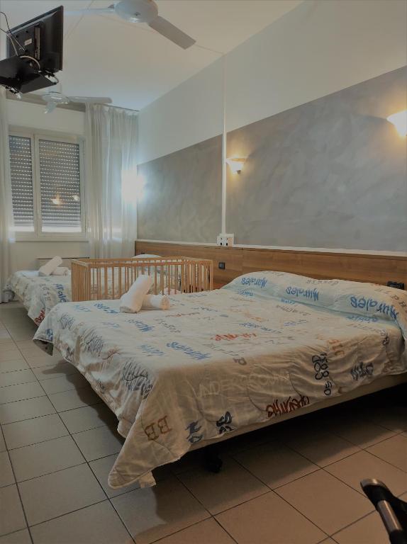 Postel nebo postele na pokoji v ubytování Hotel Marinoni