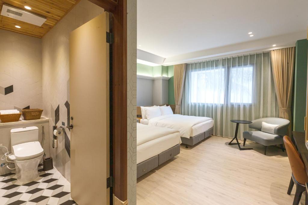 Postel nebo postele na pokoji v ubytování 墾丁耳東華苑ErDong Manor