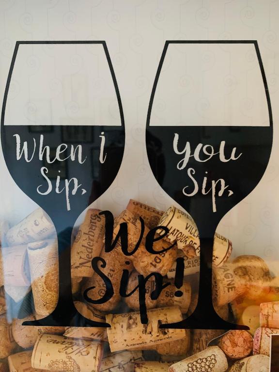 two glasses of wine with the words when i sing when you sip at Langahlid Cottages & Hot Tubs in Seyðisfjörður