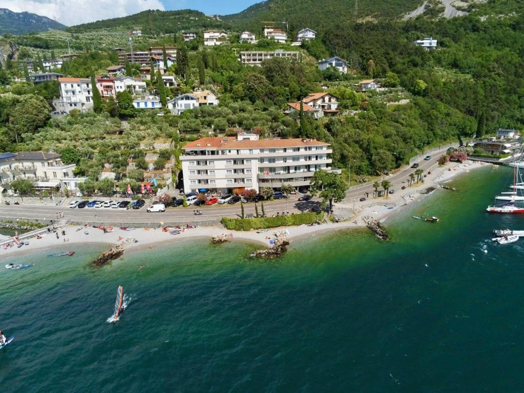 an aerial view of a beach with people in the water at Torbole Aparthotel in Nago-Torbole
