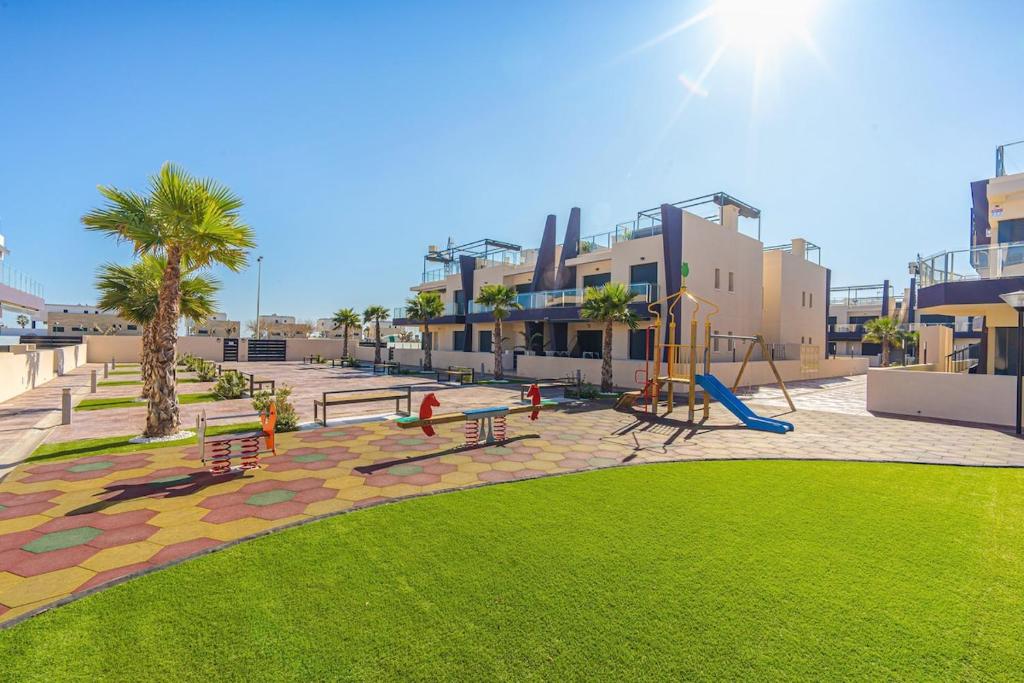 a park with a playground with a slide at Hierbas in Pilar de la Horadada