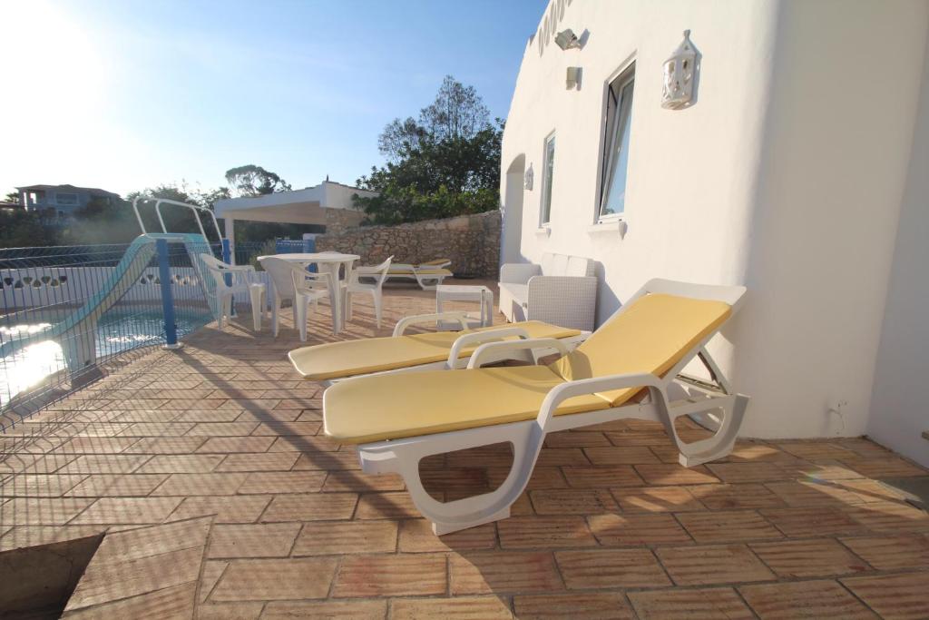 a group of chairs and tables on a patio at Casa do Milho in Carvoeiro