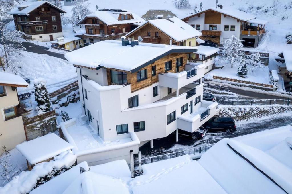 a house covered in snow in a village at Haus Sabrina Rotpleiskopf in See