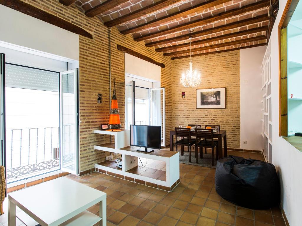 a living room with a television and a dining room at Total Valencia Charming in Valencia