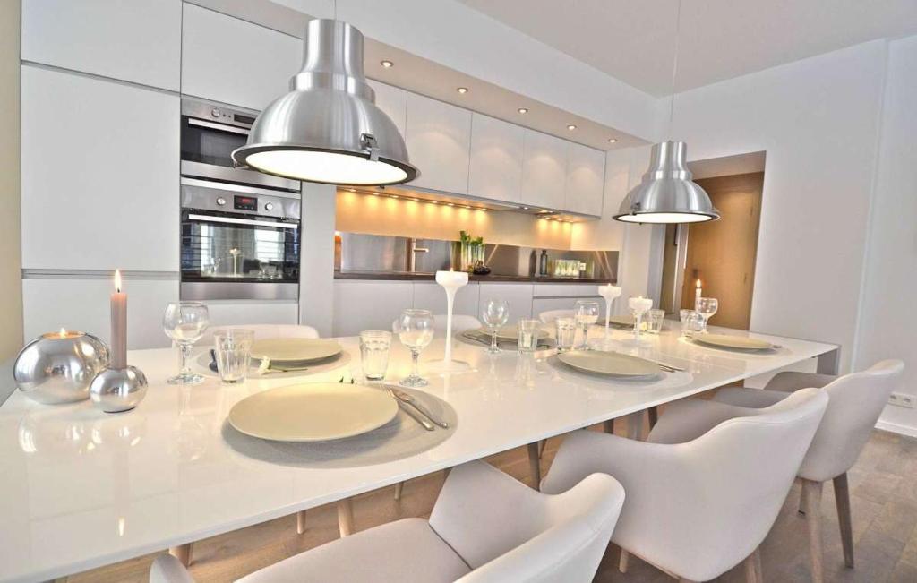 une salle à manger avec une table blanche et des chaises blanches dans l'établissement Bourbons, à Paris