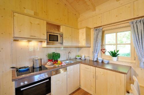 a kitchen with wooden cabinets and a counter top at Lamplhof in Rimsting