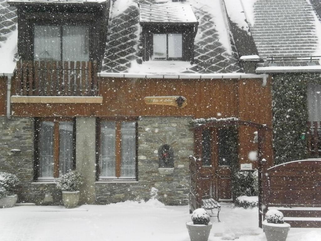 una casa con nieve en el suelo delante de ella en grand gite, en Cier-de-Luchon