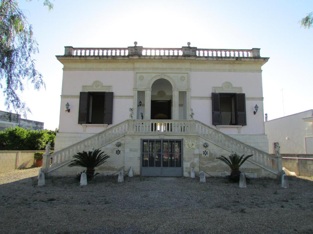 un edificio antiguo con una escalera delante en Villa Li Putti Luxury B&B, en Galatone