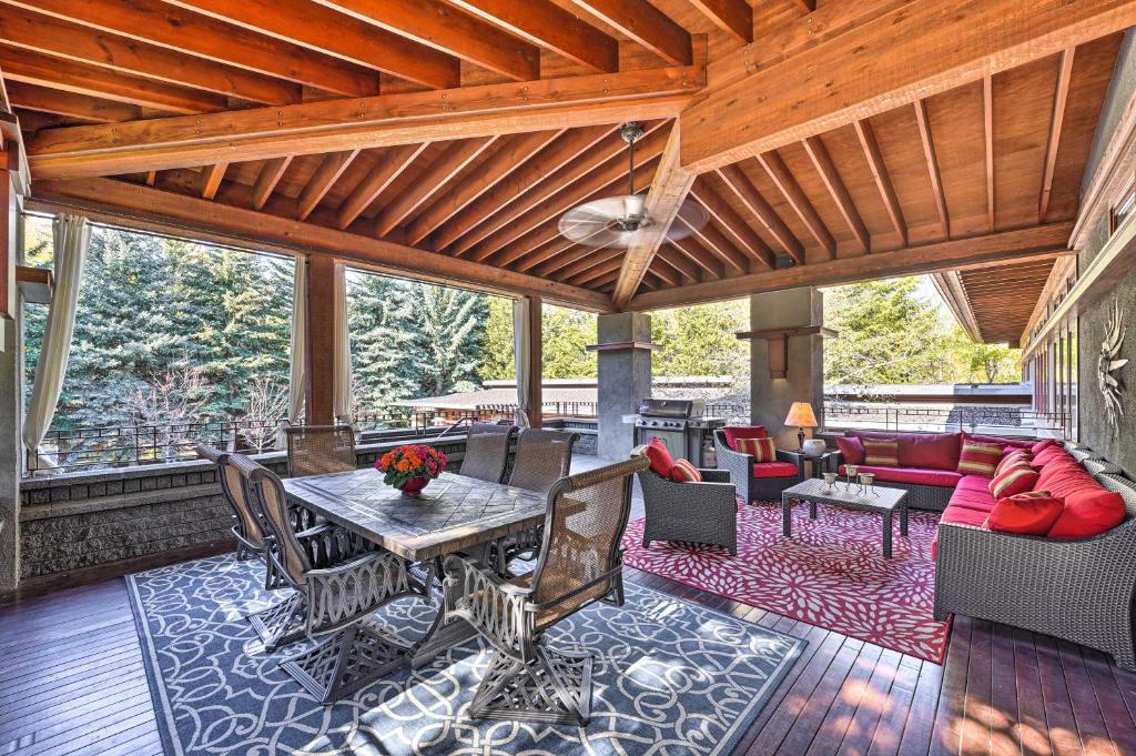 a screened in porch with a table and chairs at Spacious Luxury Retreat with Private Hot Tub and Pool! in Hailey