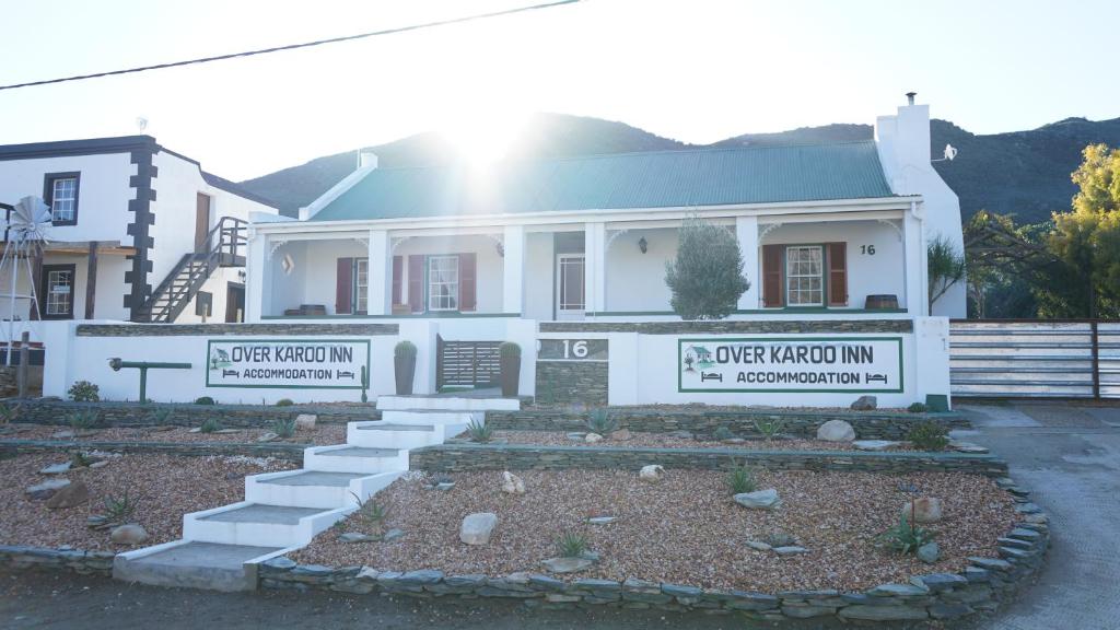 a white house with a sign for an offeway inn at Over Karoo Inn in Barrydale