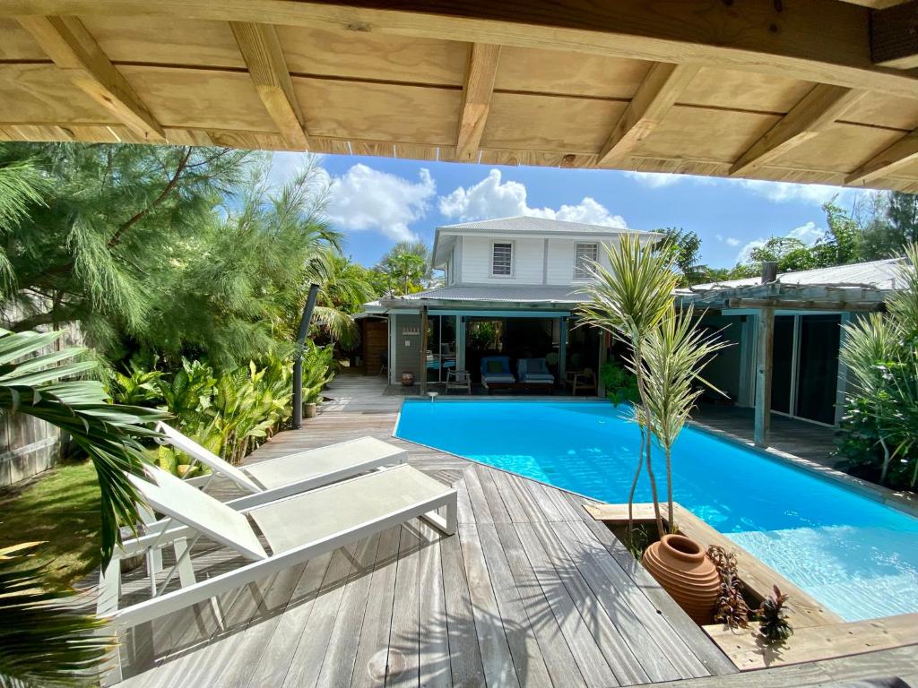 an image of a house with a swimming pool at Villa Aloha in Saint-François