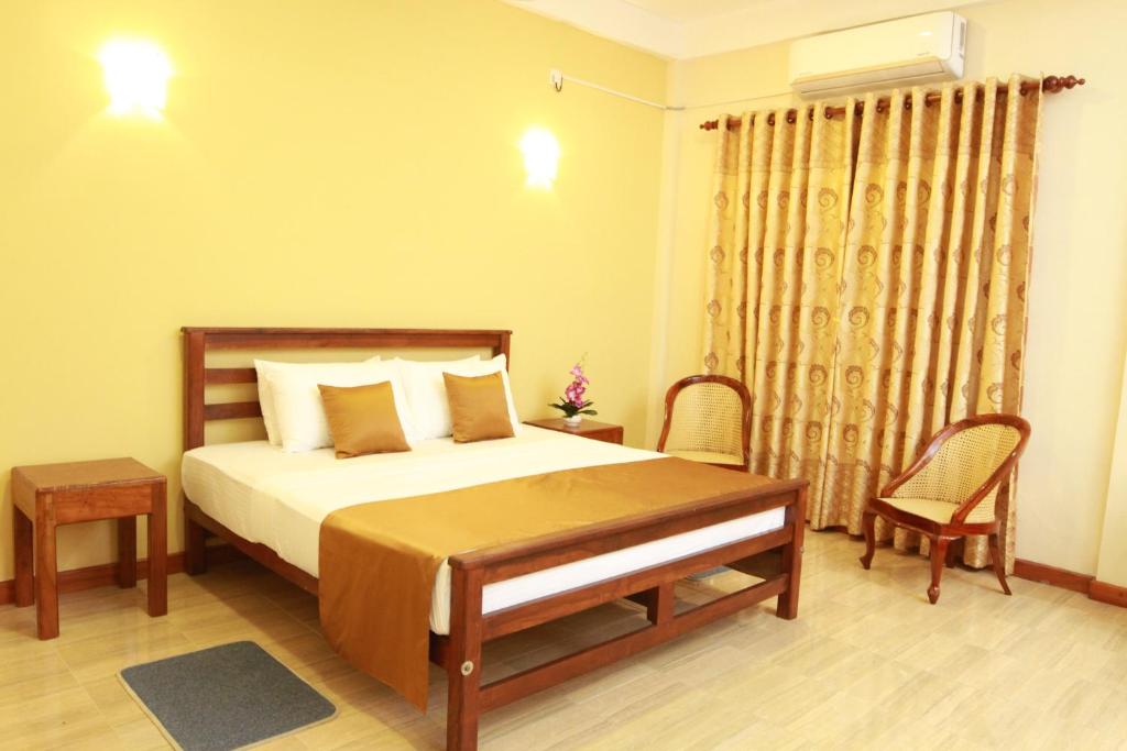 Postel nebo postele na pokoji v ubytování Hotel Nilketha Yala Tissamaharama