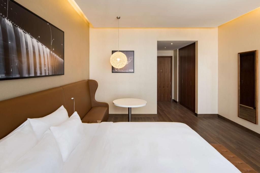 A bed or beds in a room at Radisson Blu Hotel, Dubai Canal View