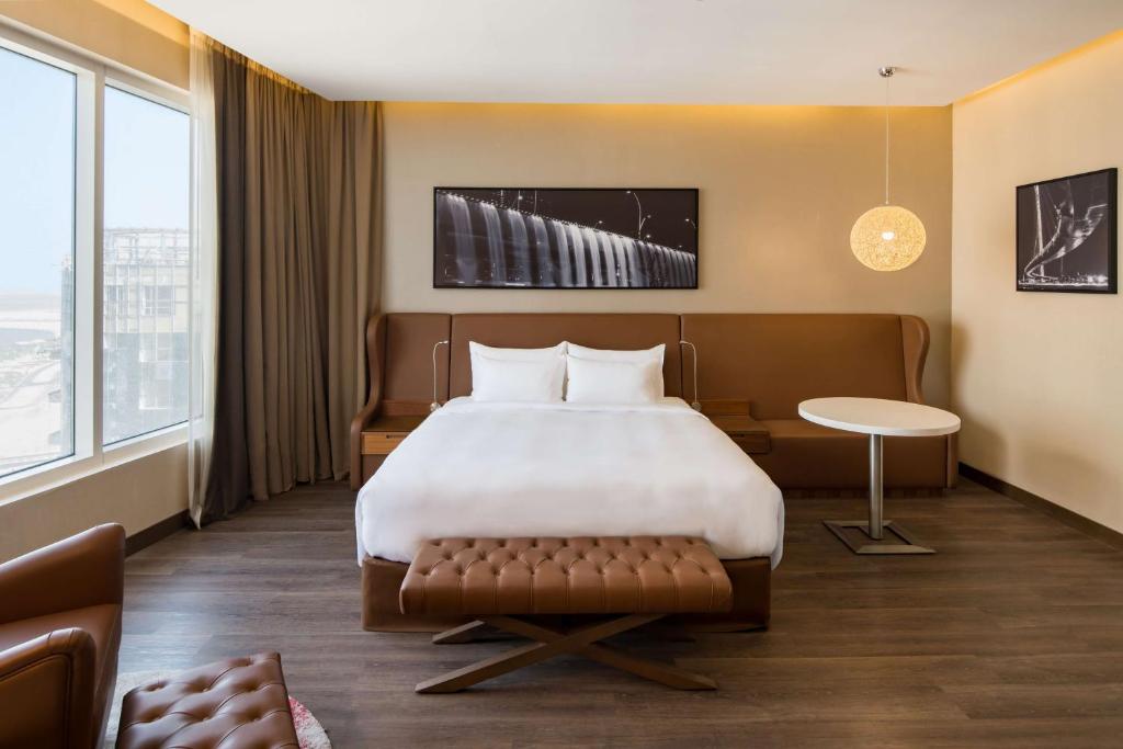 A bed or beds in a room at Radisson Blu Hotel, Dubai Canal View