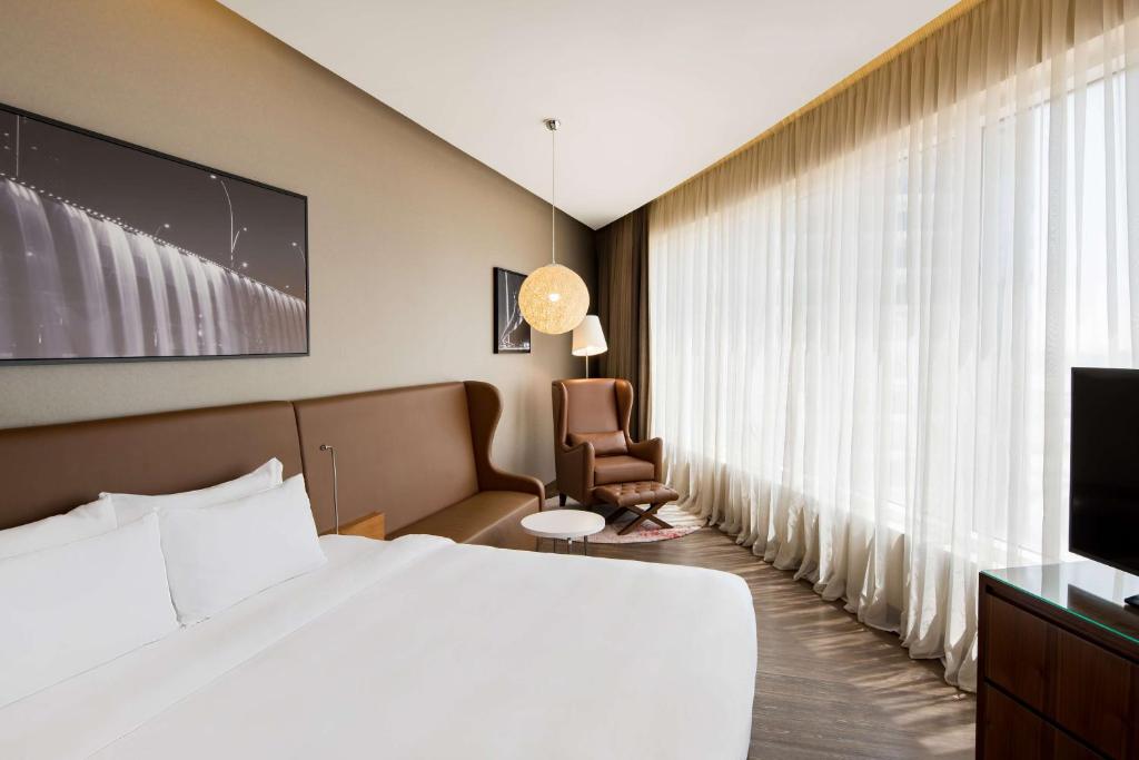 A bed or beds in a room at Radisson Blu Hotel, Dubai Canal View