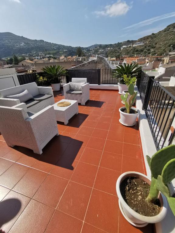 a patio with chairs and plants on a roof at Lo Nardo Accommodation in Lipari