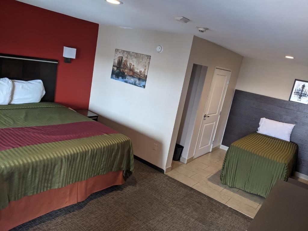 Postel nebo postele na pokoji v ubytování Epic Hotel