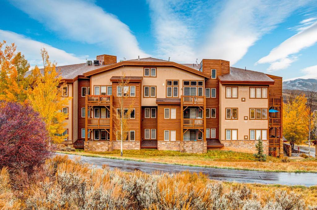 a large apartment building with a road in front of it at Cozy Crestview Condo in Park City