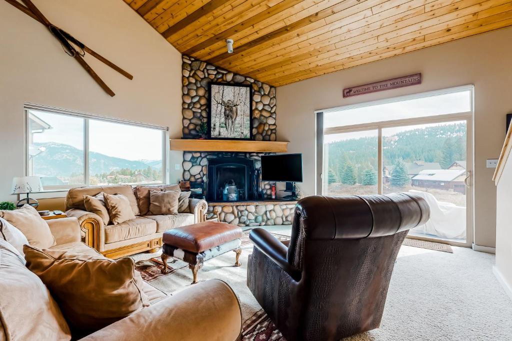 a living room with a couch and a fireplace at Firelight Chalet 94 in Big Sky