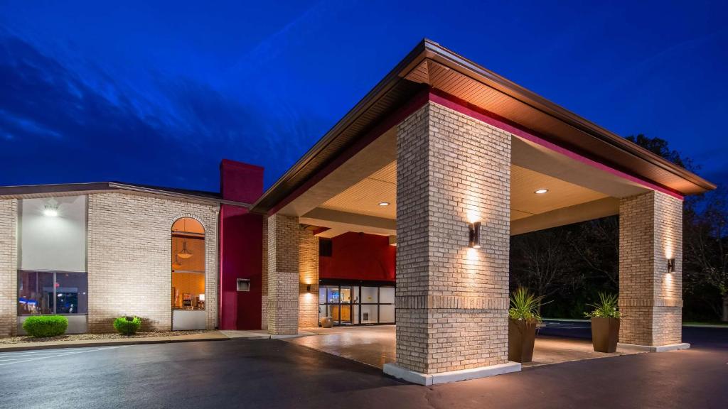 a brick building with a garage at night at Best Western Plus North Canton Inn & Suites in North Canton