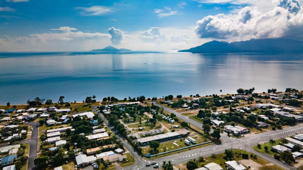 an aerial view of a city next to the water at Cardwell Beachcomber Motel & Tourist Park in Cardwell