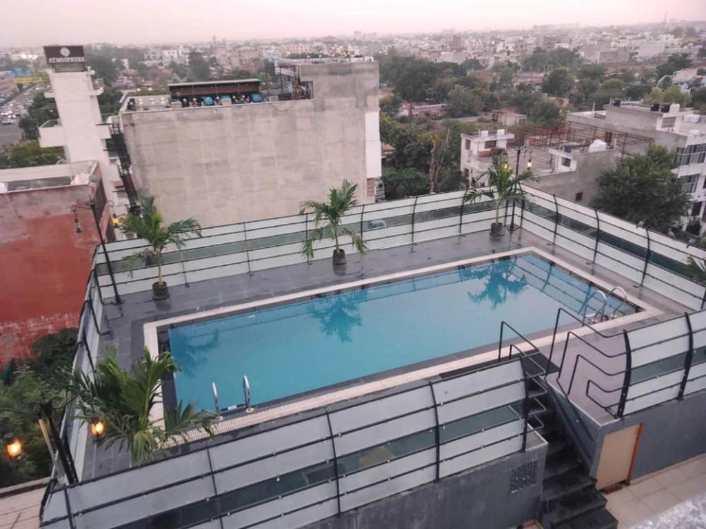 a swimming pool on top of a building at Hotel Bhaskar in Jaipur