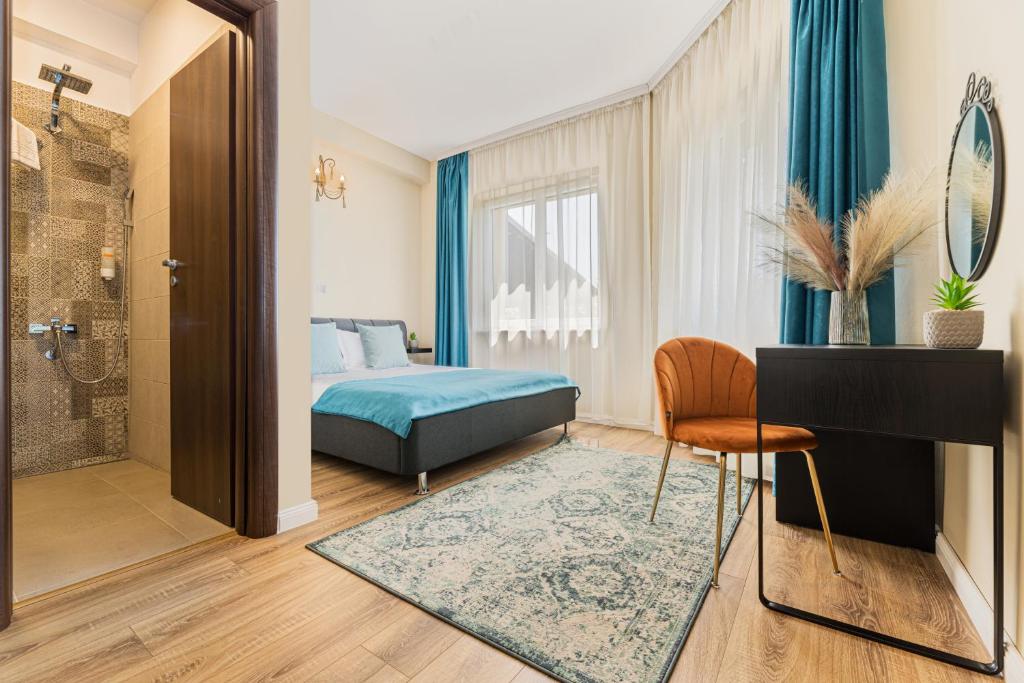 a hotel room with a bed and a bathroom at Orchard Villa in Braşov
