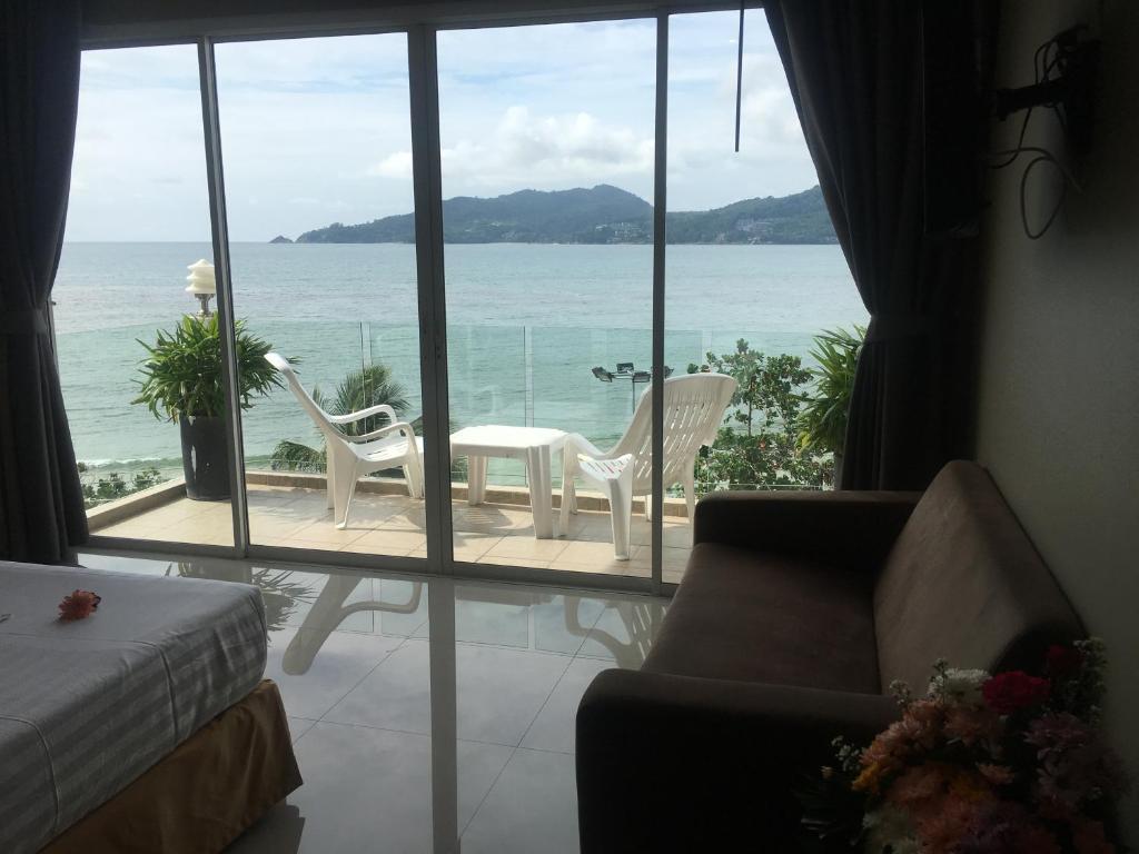 a living room with a view of the ocean at The Front Hotel and Apartments in Patong Beach