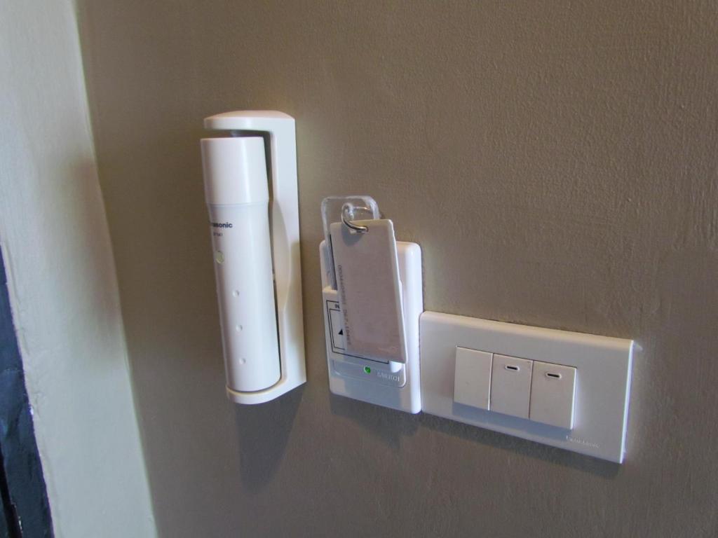 a nintendo wii controller hanging on a wall at The Front Hotel and Apartments in Patong Beach